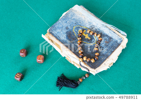church book, worry beads and three wooden dices church book, worry beads and three wooden dices 49788911