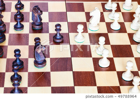 side view of chess gameplay on chessboard close up side view of chess gameplay on chessboard close up 49788964
