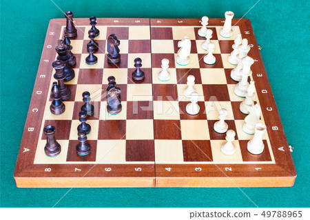 side view of chess gameplay on wooden chessboard 49788965