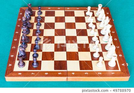 side view of wooden chessboard with chess pieces side view of wooden chessboard with chess pieces 49788970