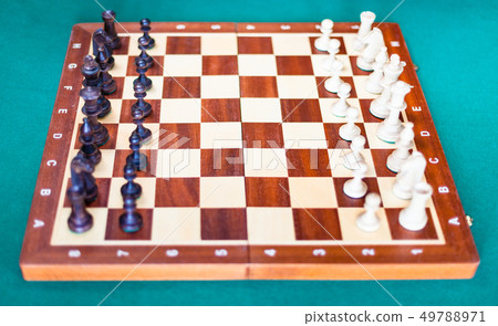 chessboard with chess pieces in starting position 49788971
