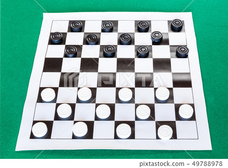 checkers on black and white checkered sheet board 49788978