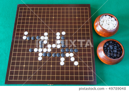 gameplay of Go game and playing stones in bowls 49789048