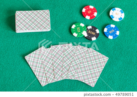 card decks and casino tokens on green table 49789051