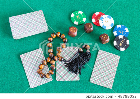 cards, wooden dices, casino tokens and worry beads 49789052