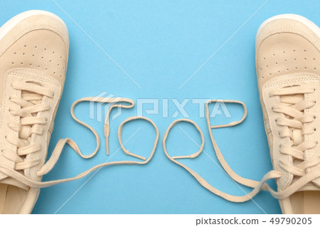 Women sneakers with laces in stoop text. 49790205