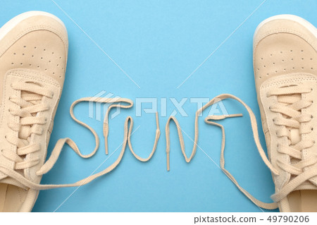 Women sneakers with laces in stunt text. Women sneakers with laces in stunt text. 49790206