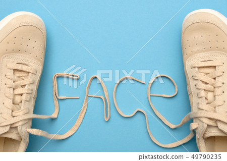 Women sneakers with laces in face text. 49790235