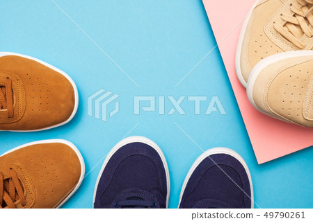 Three pair of sneakers on colored background 49790261