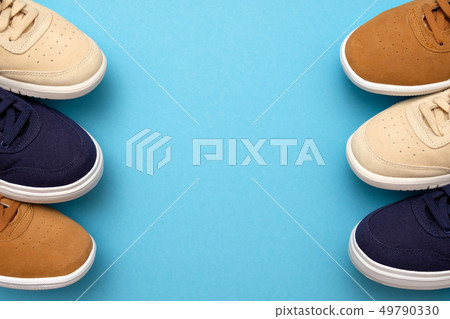 Pair of new sneakers on blue background Pair of new sneakers on blue background 49790330