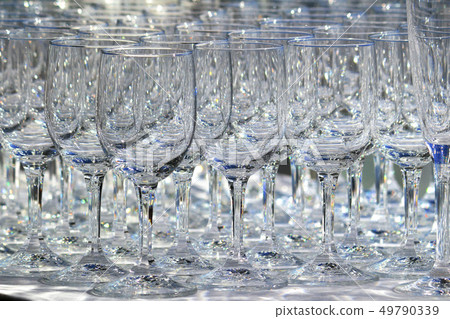 Many glasses lined up at the counter 49790339