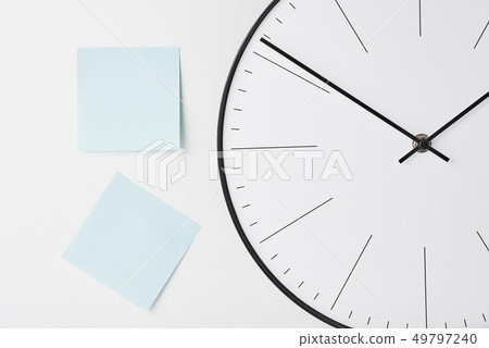Round wall clock and blue stickers on white 49797240