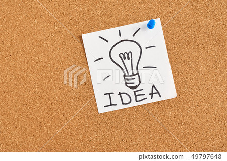 painted light bulb with word idea on a cork board 49797648