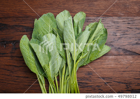 CHINESE KALE on wooden blackground CHINESE KALE on wooden blackground 49798012