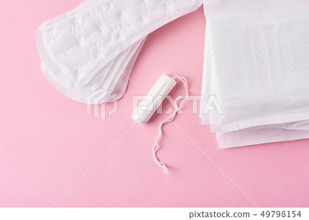 Sanitary pad and menstrual tampon on a pink Sanitary pad and menstrual tampon on a pink 49798154