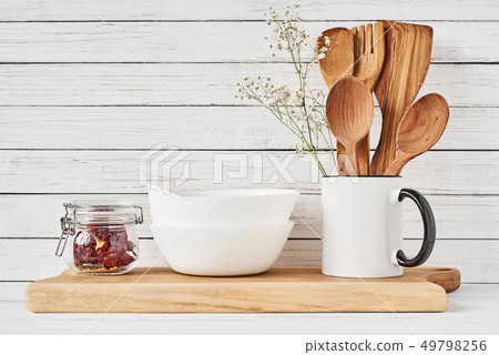 Kitchen tools and cutting board on white table 49798256