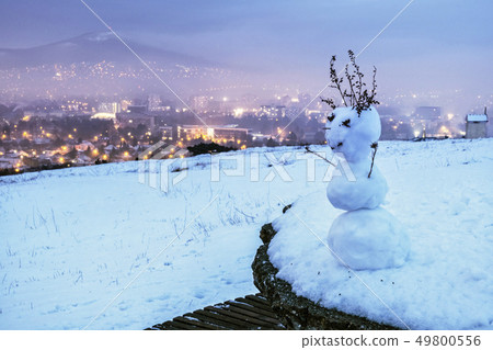 Snowman and Nitra city, Slovakia, evening photo Snowman and Nitra city, Slovakia, evening photo 49800556