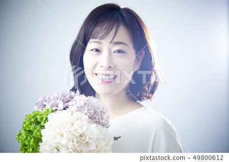 A woman holding a bouquet A woman holding a bouquet 49800612
