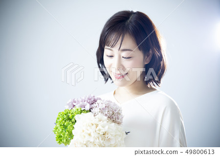 A woman holding a bouquet A woman holding a bouquet 49800613