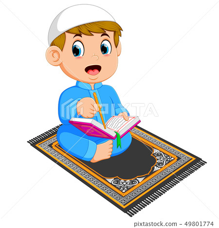 the boy is reading the al quran on the prayer rug 49801774