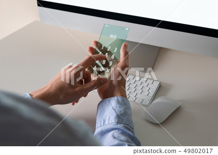 Man uses a futuristic smartphone Man uses a futuristic smartphone 49802017