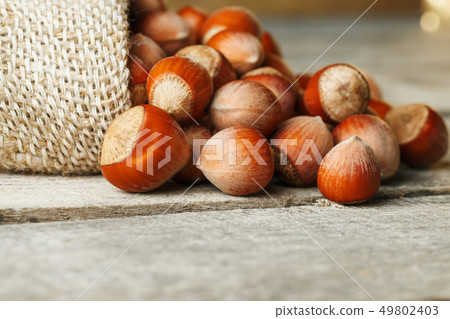 Hazelnuts in a cover, poured out from a bag from 49802403