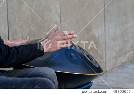 street performer playinh hang metal drum 49803695