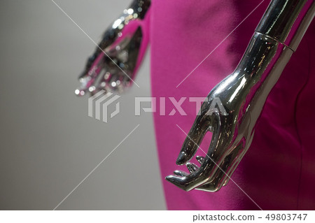 Silver woman mannequin hand detail with pink dress 49803747