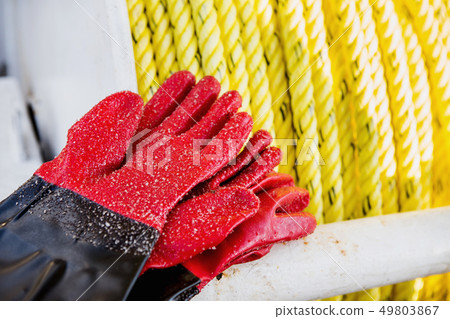 Fishing gloves covered with sand Fishing gloves covered with sand 49803867