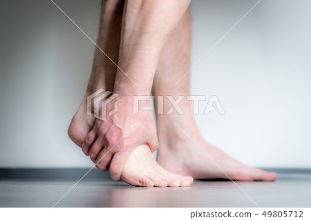 man with pain in foot 49805712