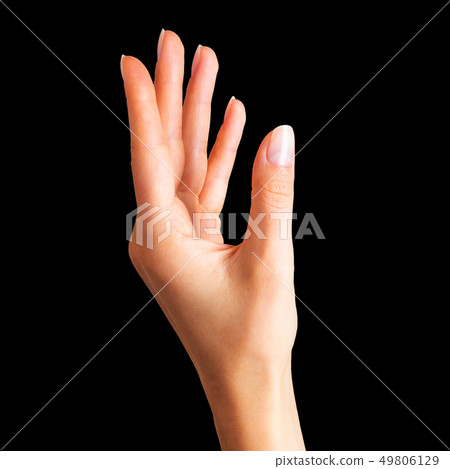 Woman hand holding something with two fingers Woman hand holding something with two fingers 49806129