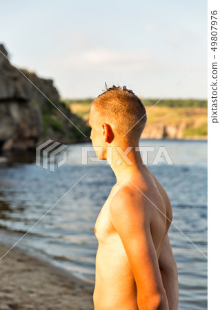 guy portrait on the background of river beach guy portrait on the background of river beach 49807976