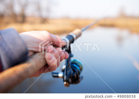 Fisherman hand holding fishing rod. Fisherman hand holding fishing rod. 49808038