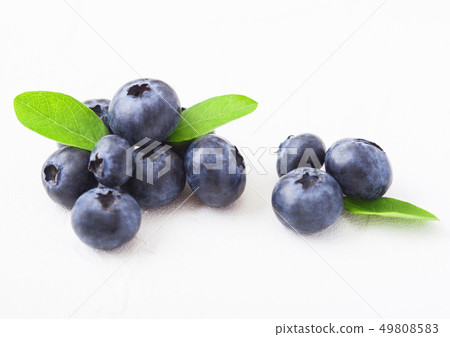 Fresh raw organic blueberries with leaf on white 49808583