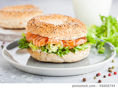 Fresh healthy bagel sandwich with salmon, ricotta Fresh healthy bagel sandwich with salmon, ricotta 49808744