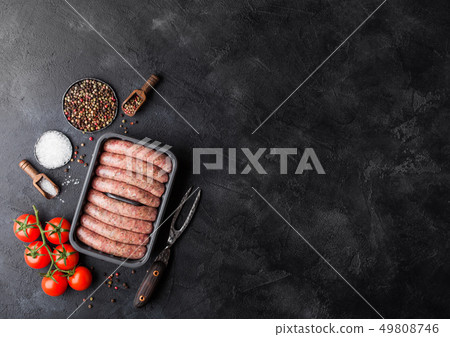 Raw beef and pork sausage in plastic tray with 49808746