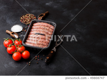 Raw beef and pork sausage in plastic tray with Raw beef and pork sausage in plastic tray with 49808747