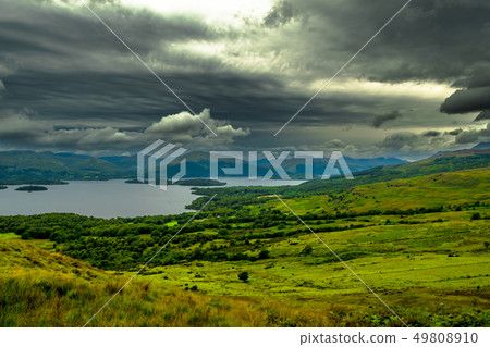 Calm Water And Green Meadows At Loch Lomond In Sco 49808910