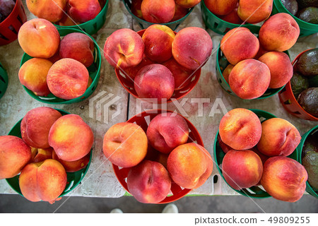 Organically grown yellow peaches for sale at local farmer market 49809255