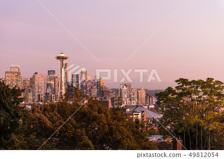 Sunset over the skyline of the city of Seattle and the profile of Mount Rainier in the background. 49812054