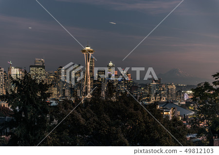 Sunset over the skyline of the city of Seattle and the profile of Mount Rainier in the background. 49812103