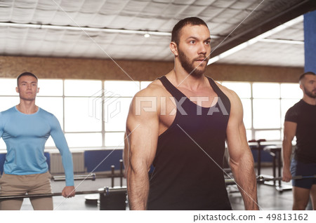 Portrait of Young Strong Man Training with Barbell 49813162
