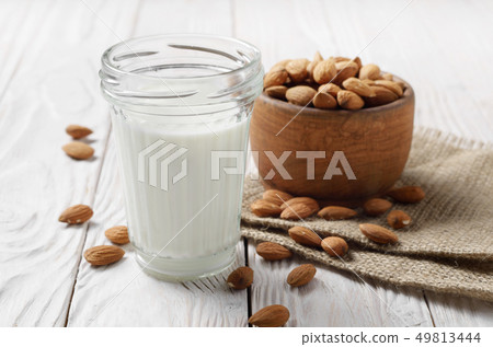 Milk or yogurt in mason jar on white wooden table 49813444