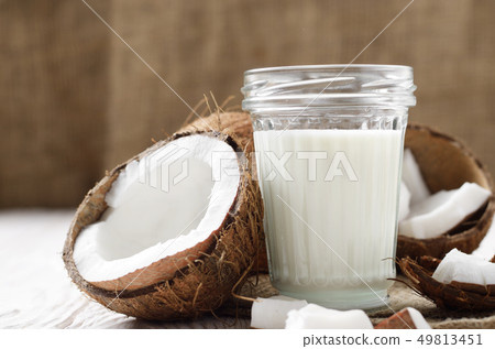 Mason jar of milk or yogurt on hemp napkin on 49813451
