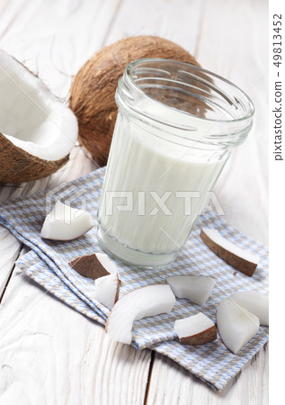 Mason jar of milk or yogurt on blue napkin on 49813452