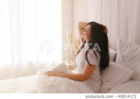 Happy woman waking up after good sleeping 49814172