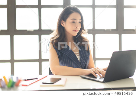 Portrait of smiling pretty young Asian business 49815456