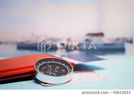 Time to Travel. Idea for tourism with passport, tickets and compass on the background of the sea and Time to Travel. Idea for tourism with passport, tickets and compass on the background of the sea and 49818055