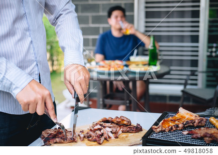 Group of friends Two young man enjoying grilled Group of friends Two young man enjoying grilled 49818058