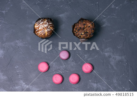 cupcake and French macaron on a dark background 49818515